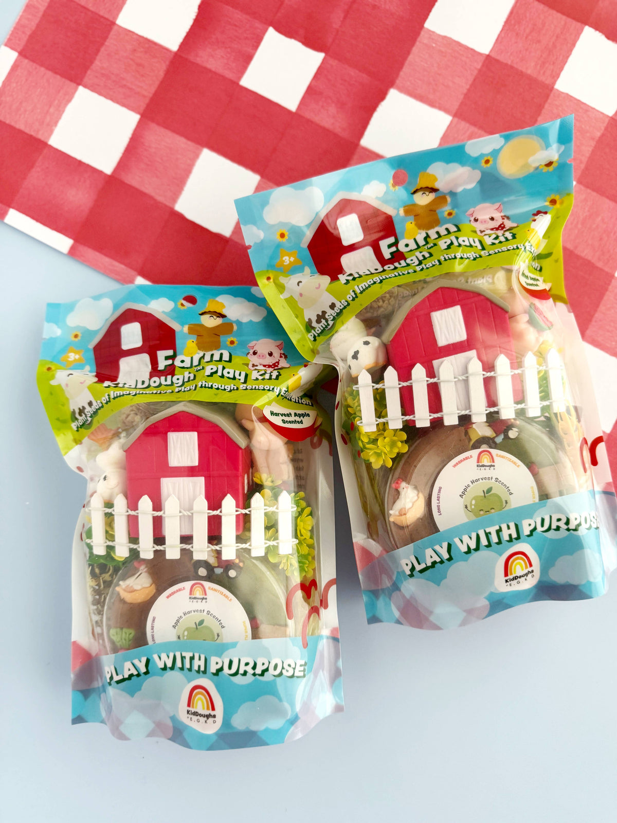 farm-themed play kits with packaging on a red and white checkered background
