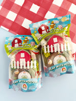 farm-themed play kits with packaging on a red and white checkered background